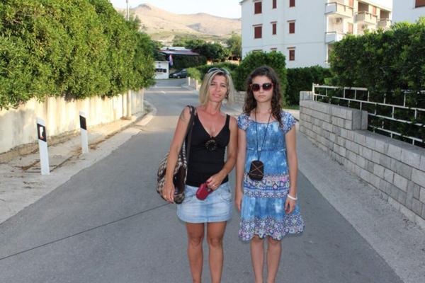 Mother teaching daughter on vacation